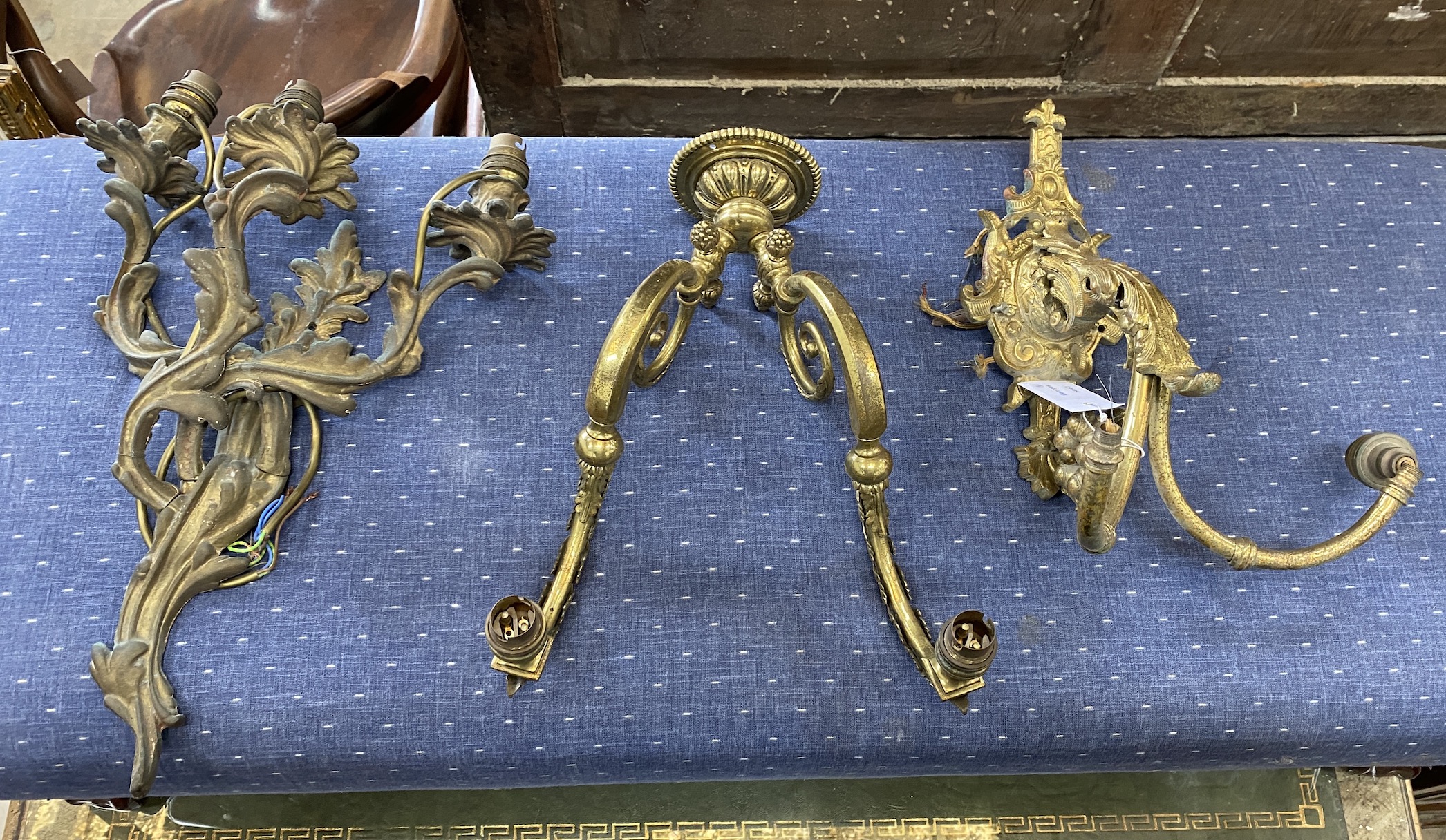 Three gilt metal wall lights, largest height 46cm